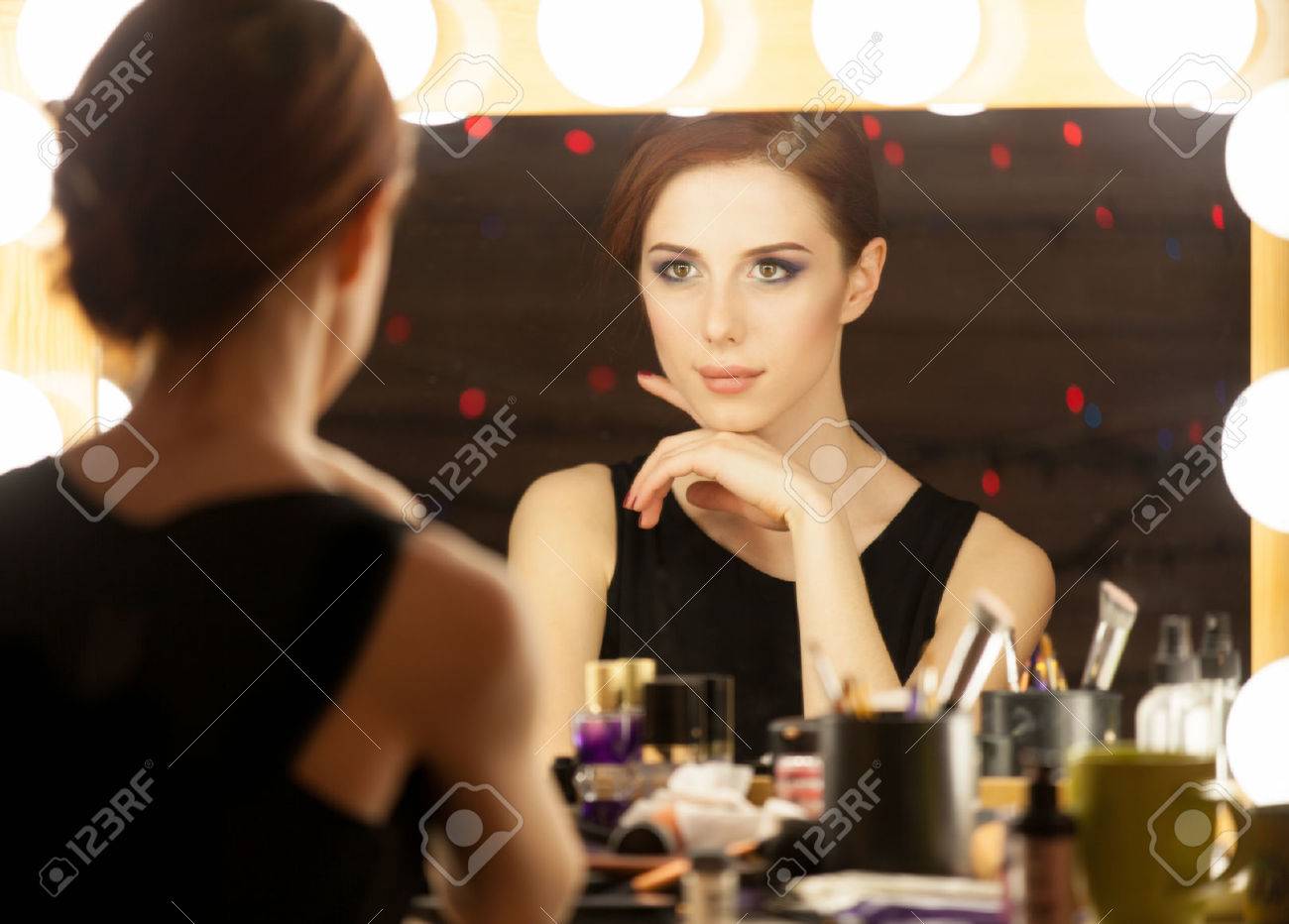 Portrait of a beautiful woman as applying makeup near a mirror. Photo in retro color style. - 39590985 Portrait of a beautiful woman as applying makeup near a mirror. Photo in retro color style. - 39590985