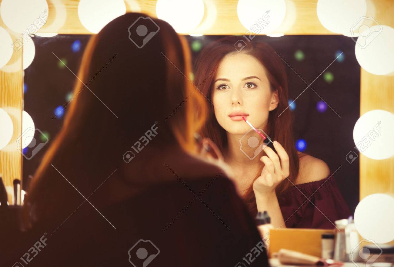 Portrait of a beautiful woman as applying makeup near a mirror. Photo in retro color style. - 43776375 Portrait of a beautiful woman as applying makeup near a mirror. Photo in retro color style. - 43776375
