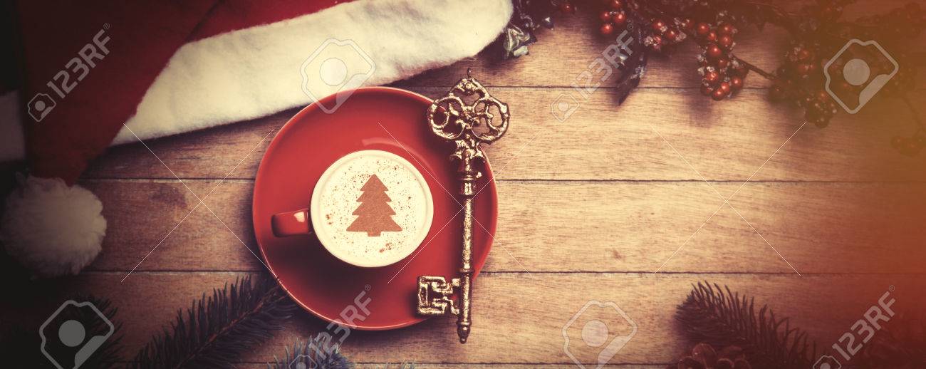 Cappuccino with key on wooden table. - 44352394 Cappuccino with key on wooden table. - 44352394