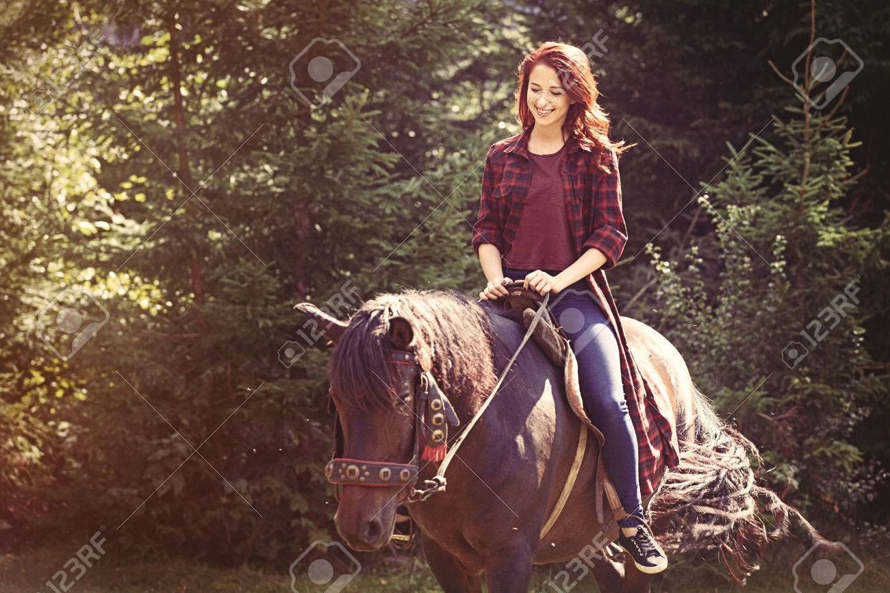 Redhead girl with horse in the forest - 45605010 Redhead girl with horse in the forest - 45605010