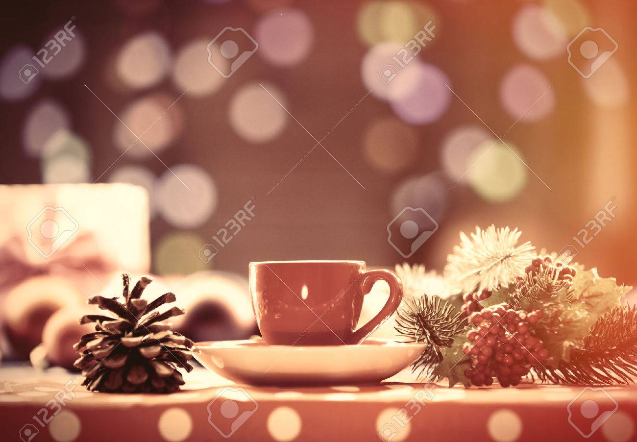 Cup of tea and branch with Christmas lights on background. - 45820998 Cup of tea and branch with Christmas lights on background. - 45820998