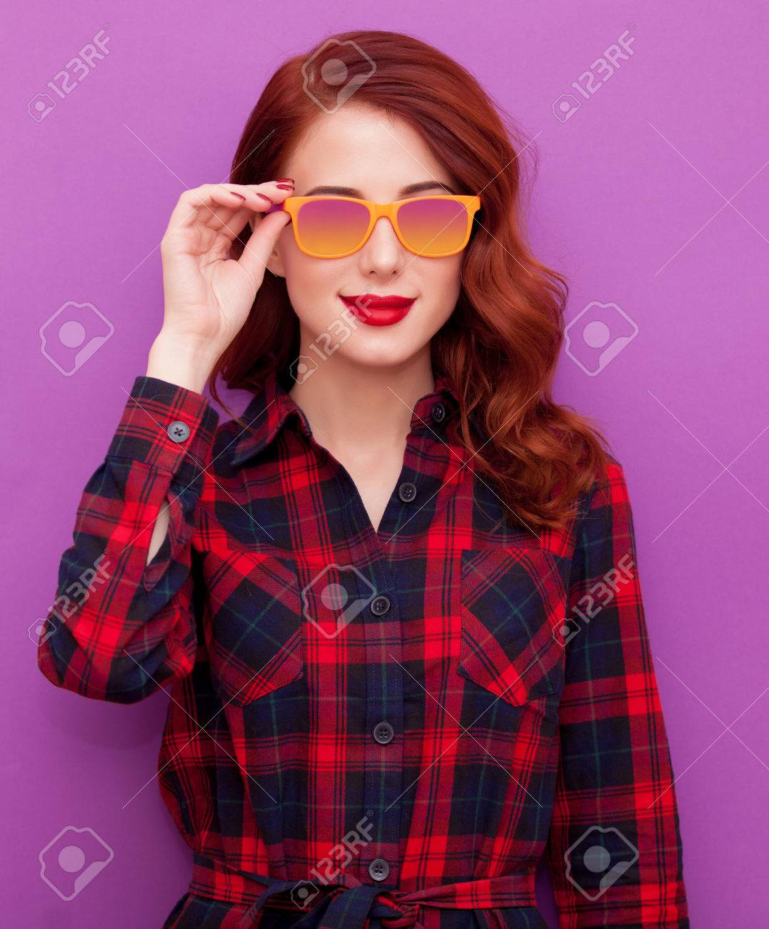 Redhead girl in sunglasses on violet background - 46650128 Redhead girl in sunglasses on violet background - 46650128