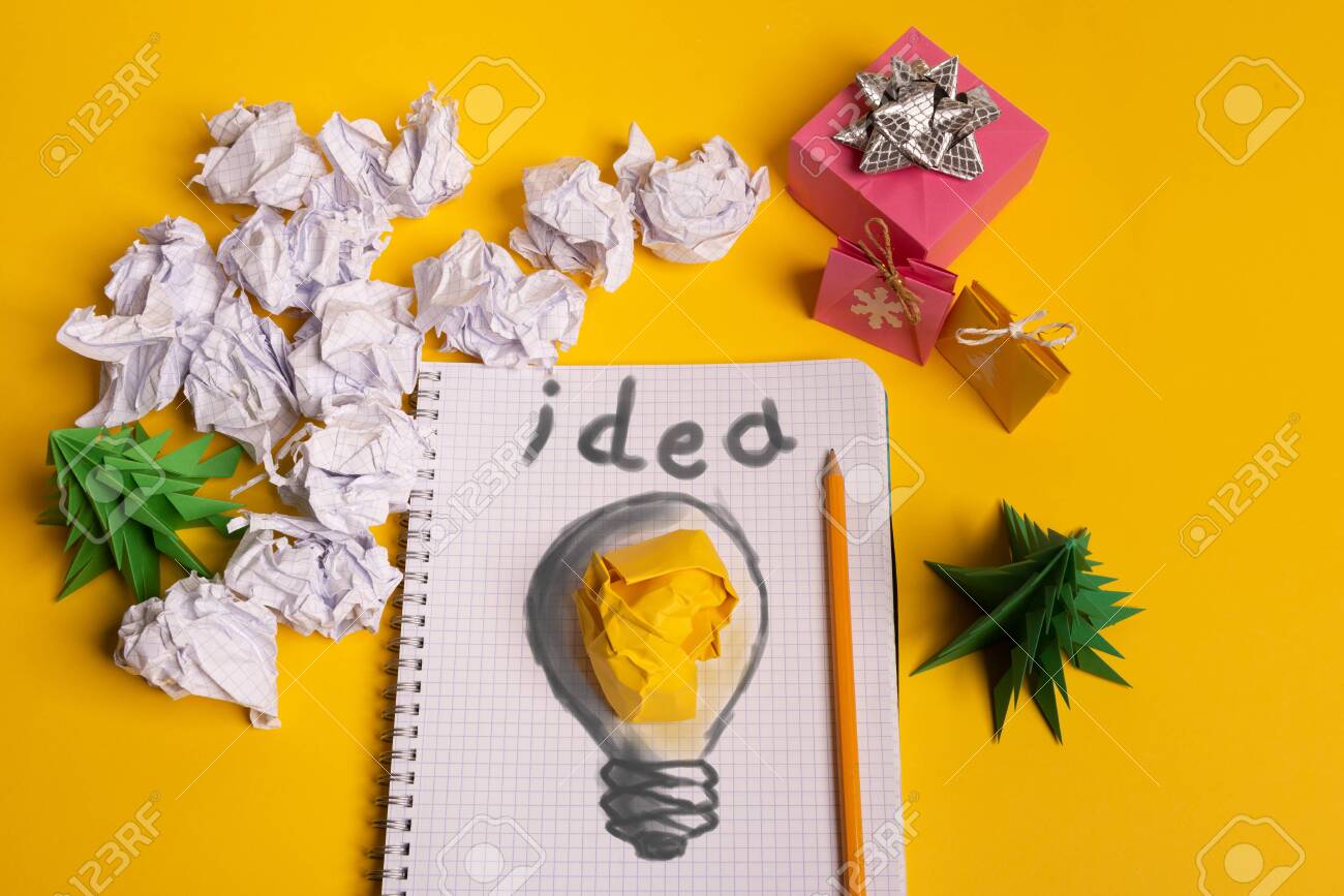Gift Box And Green Paper Origami Trees With Notepad On Yellow
