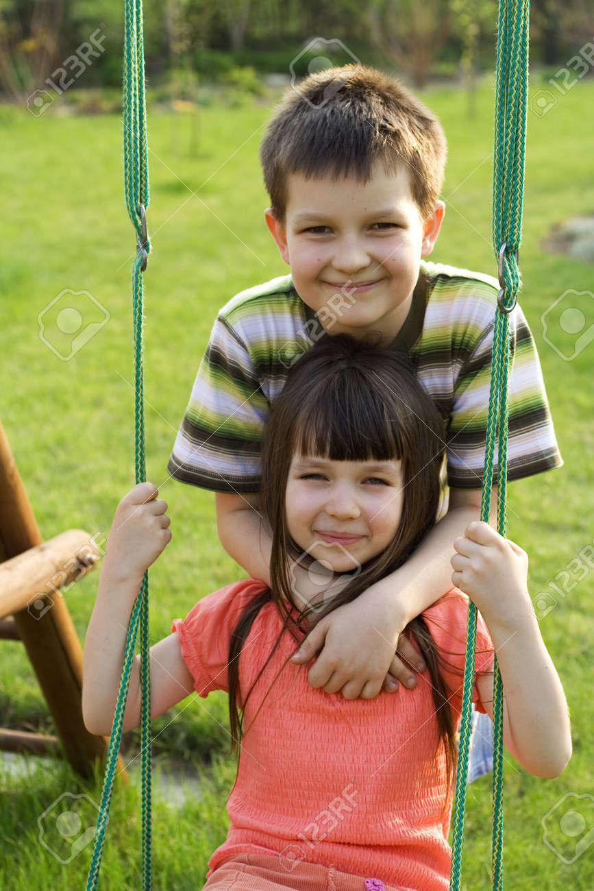 children on swing stock