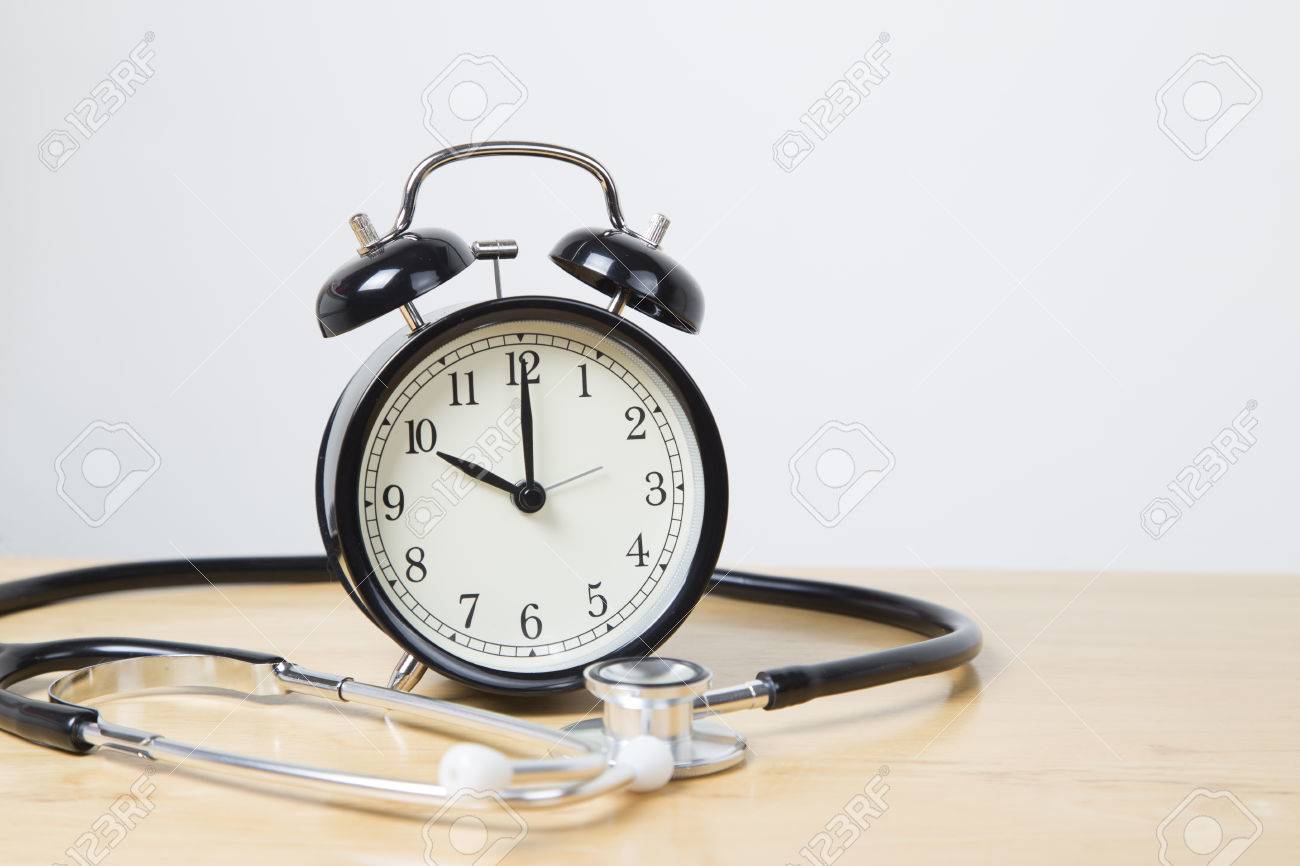 black bell alarm clock in cente of stethoscope stock photo picture