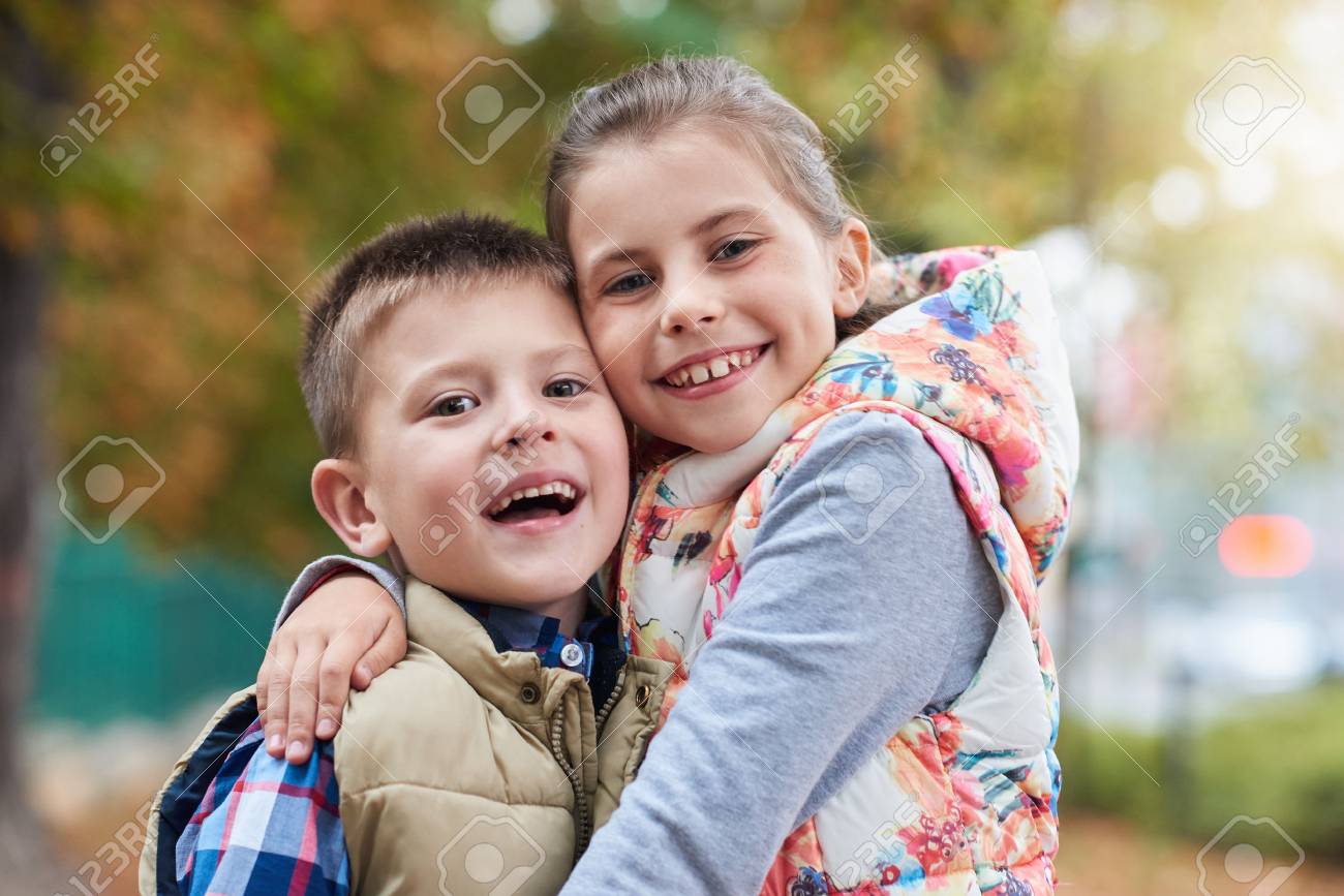 happy siblings hugging outside stock photo picture and royalty free