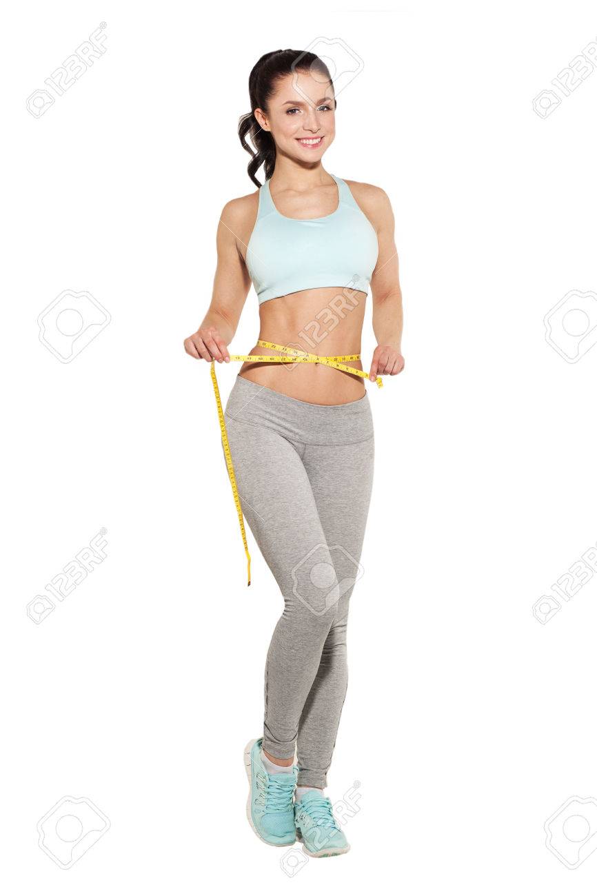 weight loss, sports girl measuring her waist, training in the gym, workout abdominals - 44694810 weight loss, sports girl measuring her waist, training in the gym, workout abdominals - 44694810