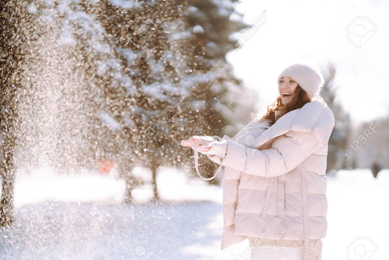 Stylish traveler walking in the snow