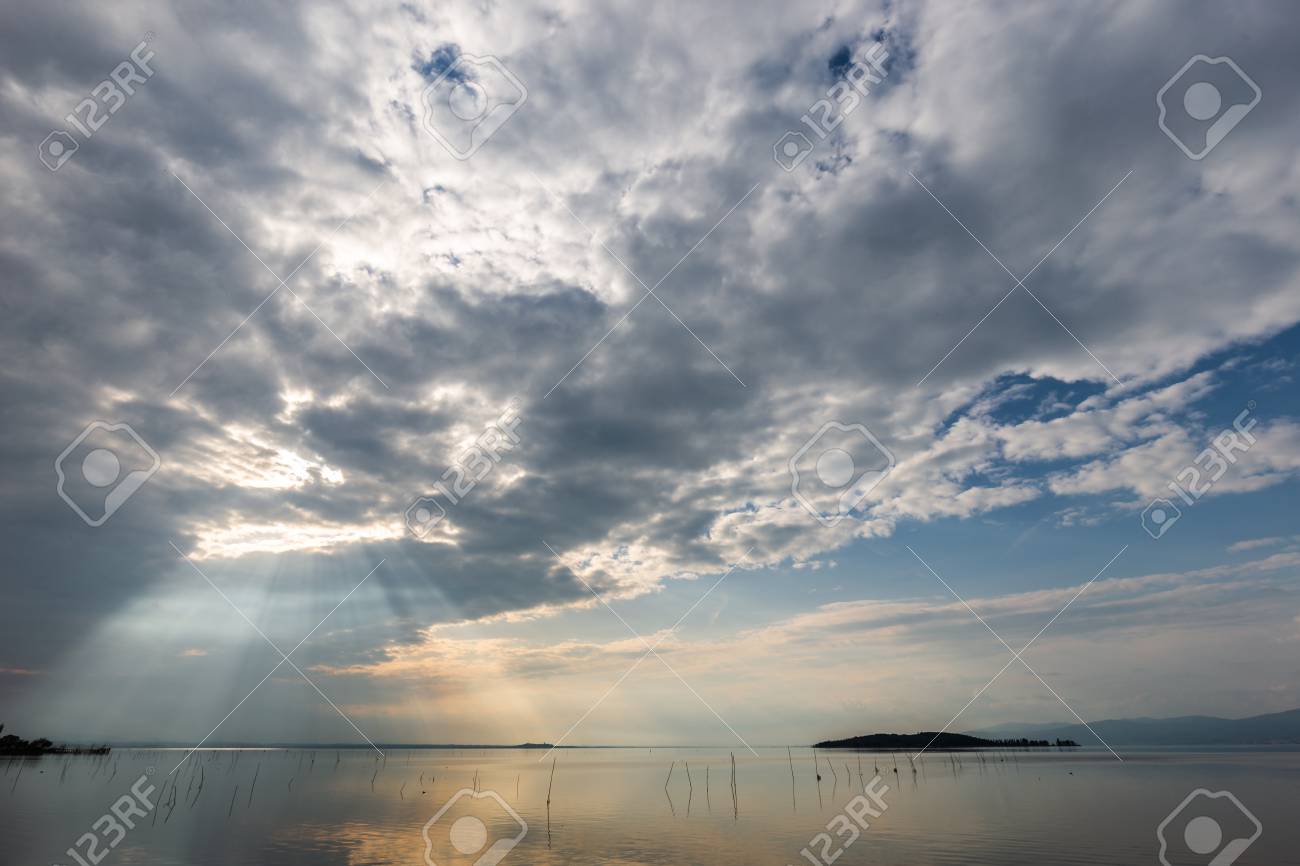 spectacular view of a lake with clouds sky and sun rays reflecting