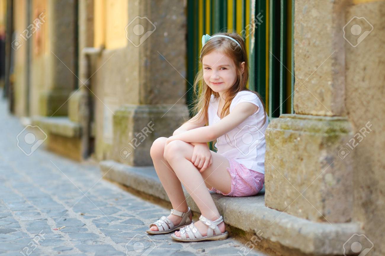 Adorable Little Girl Sitting On A Doorstep On Warm And Sunny Summer Day In Typical Italian Town Stock Photo Picture And Royalty Free Image Image