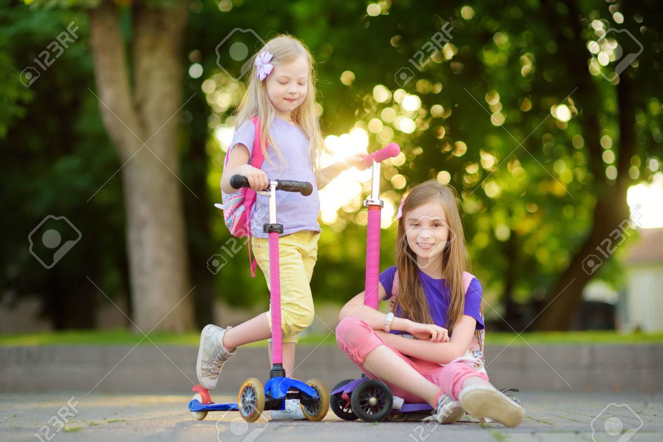 little girl riding scooter