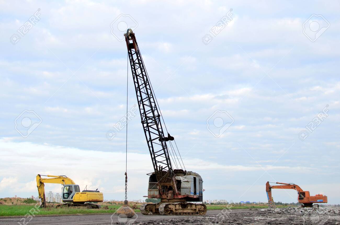Large Crawler Crane Or Dragline Excavator With A Heavy Metal Wrecking Ball On A Steel Cable Wrecking Balls At Construction Sites Dismantling And Demolition Of Buildings And Structures Stock Photo Picture And