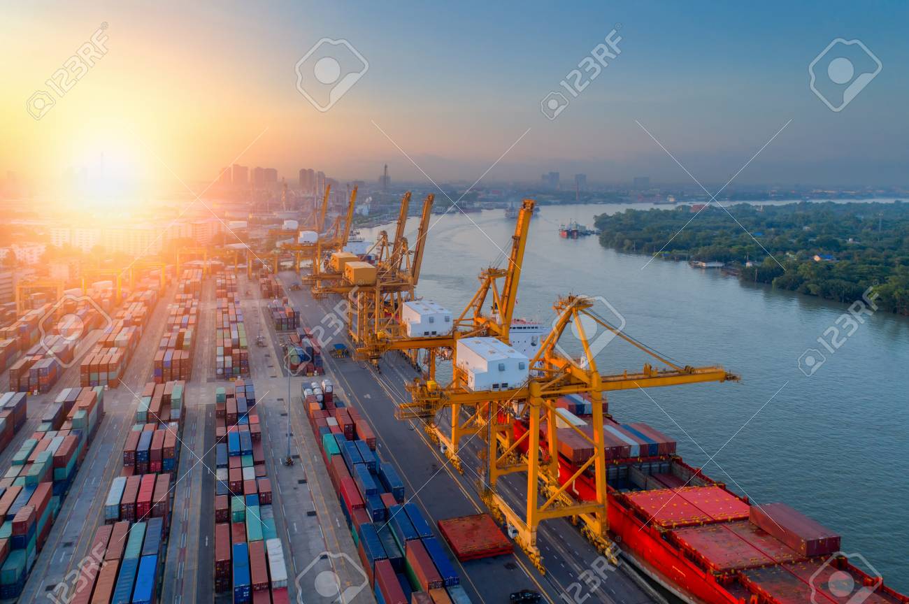 aerial view of containers yard in port congestion with ship vessels