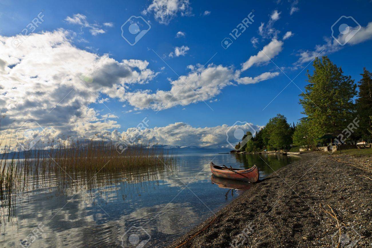 Little Kanu At A Stone Beach On Lake Orchid In Mazedonia Stock Photo Picture And Royalty Free Image Image 65841772