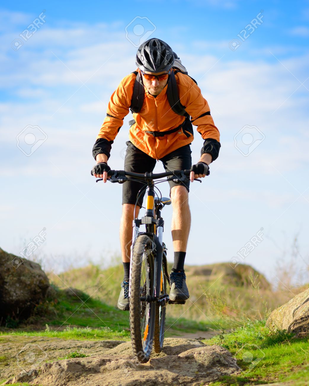Cyclist Riding the Bike on the Beautiful Spring Mountain Trail - 25067634 Cyclist Riding the Bike on the Beautiful Spring Mountain Trail - 25067634