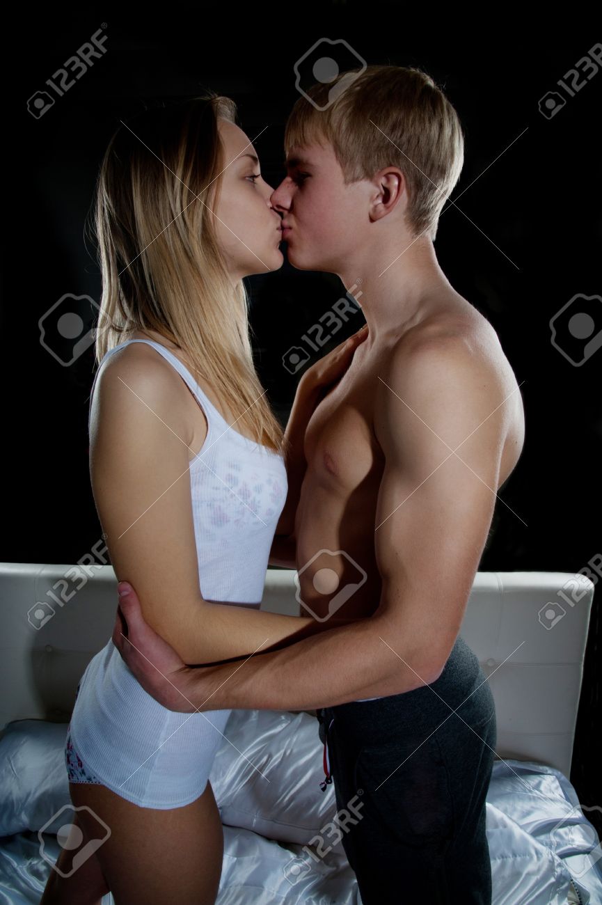 Young Girl And Boy Kissing In Bedroom Stock Photo, Picture and Royalty Free  Image. Image 16906625.