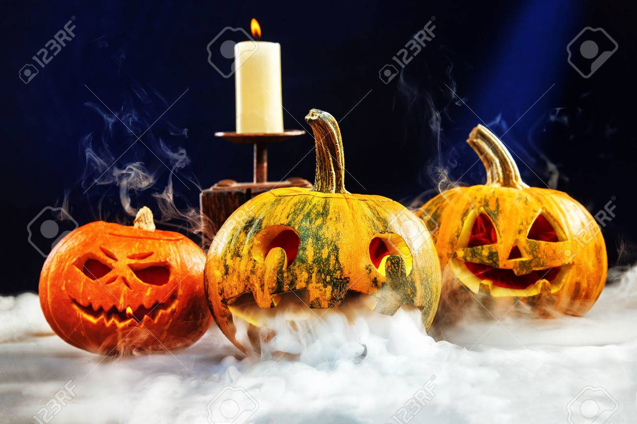 Halloween Wallpaper With Three Jack O Lantern Pumpkins Surrounded Halloween Wallpaper With Three Jack O Lantern Pumpkins Surrounded