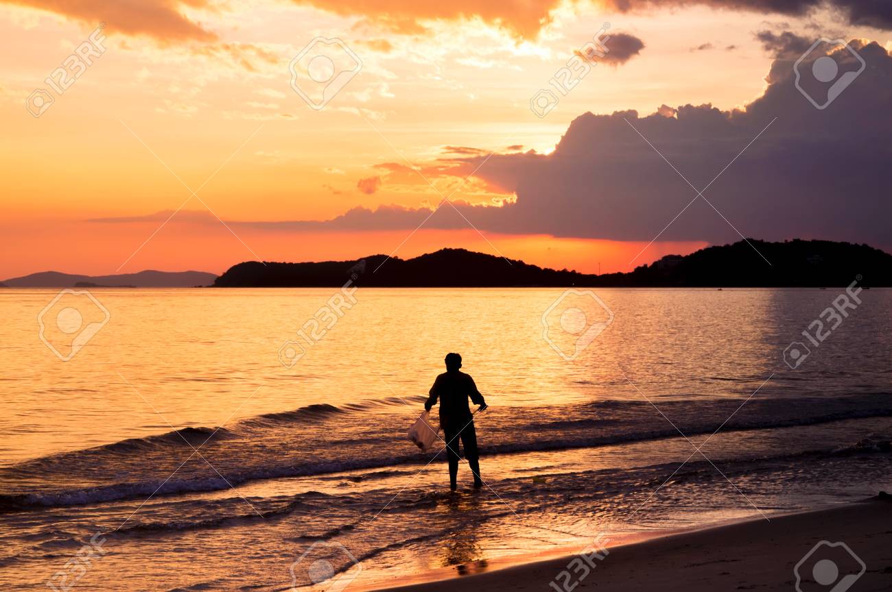 Silhouette Of Lonely Man Walking In To The Sea At Sunset Stock Photo Picture And Royalty Free Image Image