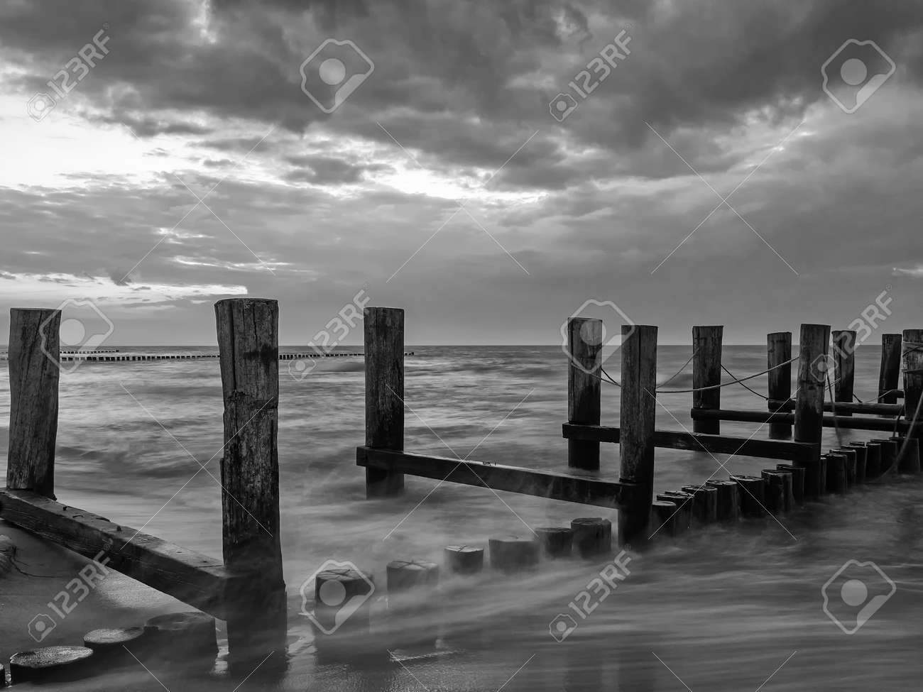 Monochrome image of a groyne in the Baltic Sea near to Zingst, Mecklenburg-Western Pomerania, at twilight - 155472855 Monochrome image of a groyne in the Baltic Sea near to Zingst, Mecklenburg-Western Pomerania, at twilight - 155472855