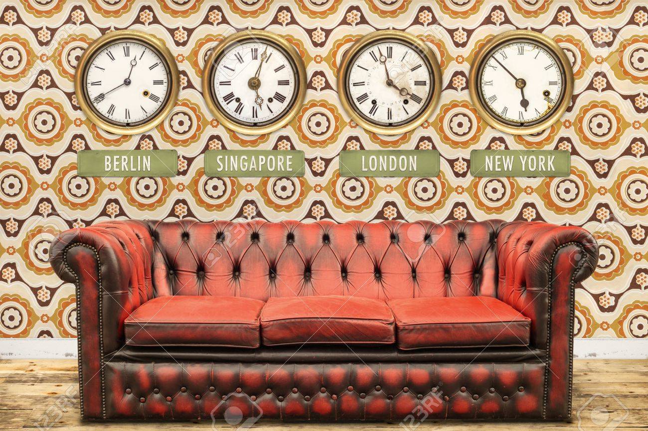 Retro Chesterfield Sofa With World Time Clocks On A Wall With