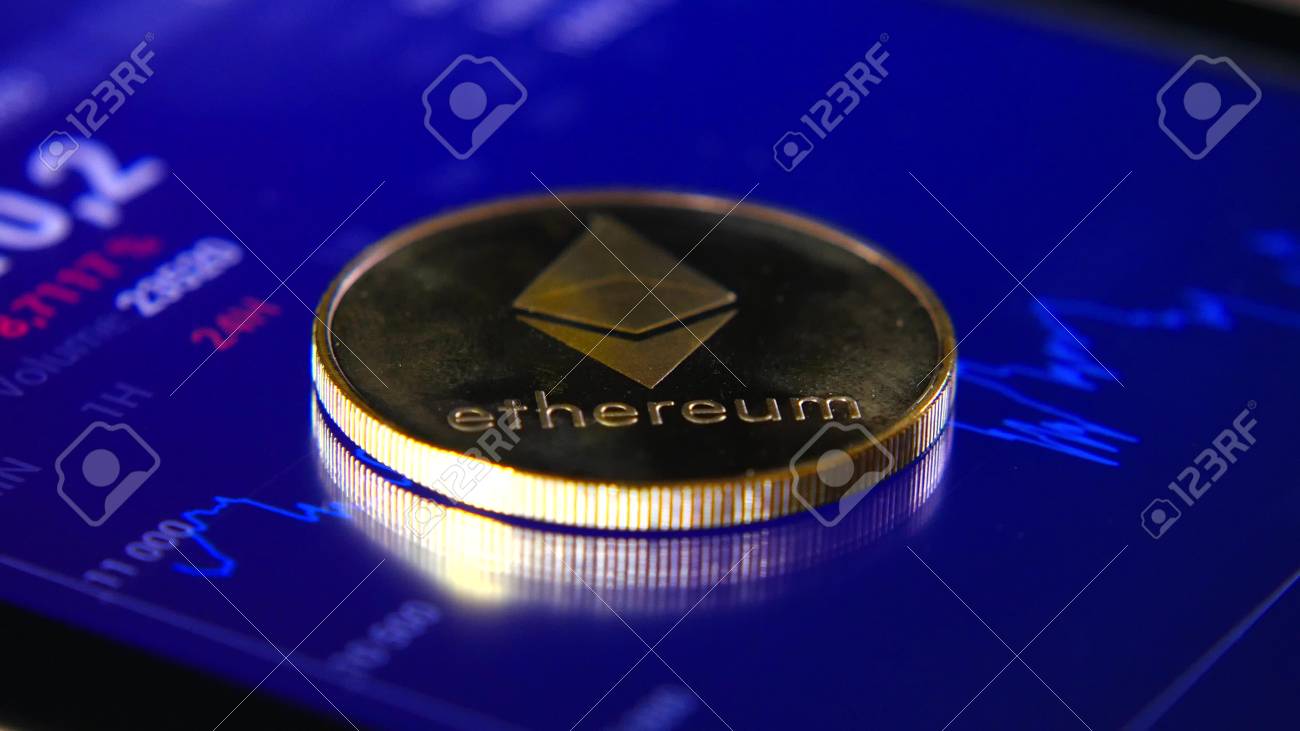 Gold coins of the ethereum on the background of a graphic stock chart. The Concentration of the Crypto-Currency of Virtual Money - 98230895 Gold coins of the ethereum on the background of a graphic stock chart. The Concentration of the Crypto-Currency of Virtual Money - 98230895
