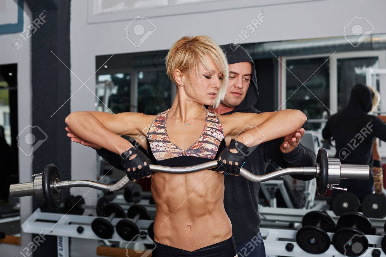 Personal Trainer Helping Blonde Woman In Press Of Weight Sporty Stock Photo Picture And Royalty Free Image Image 47102114