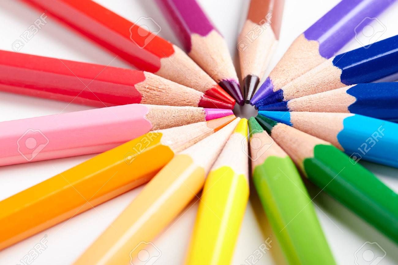 Set of multicoloured pencils lying on white table round order. - 47107458 Set of multicoloured pencils lying on white table round order. - 47107458