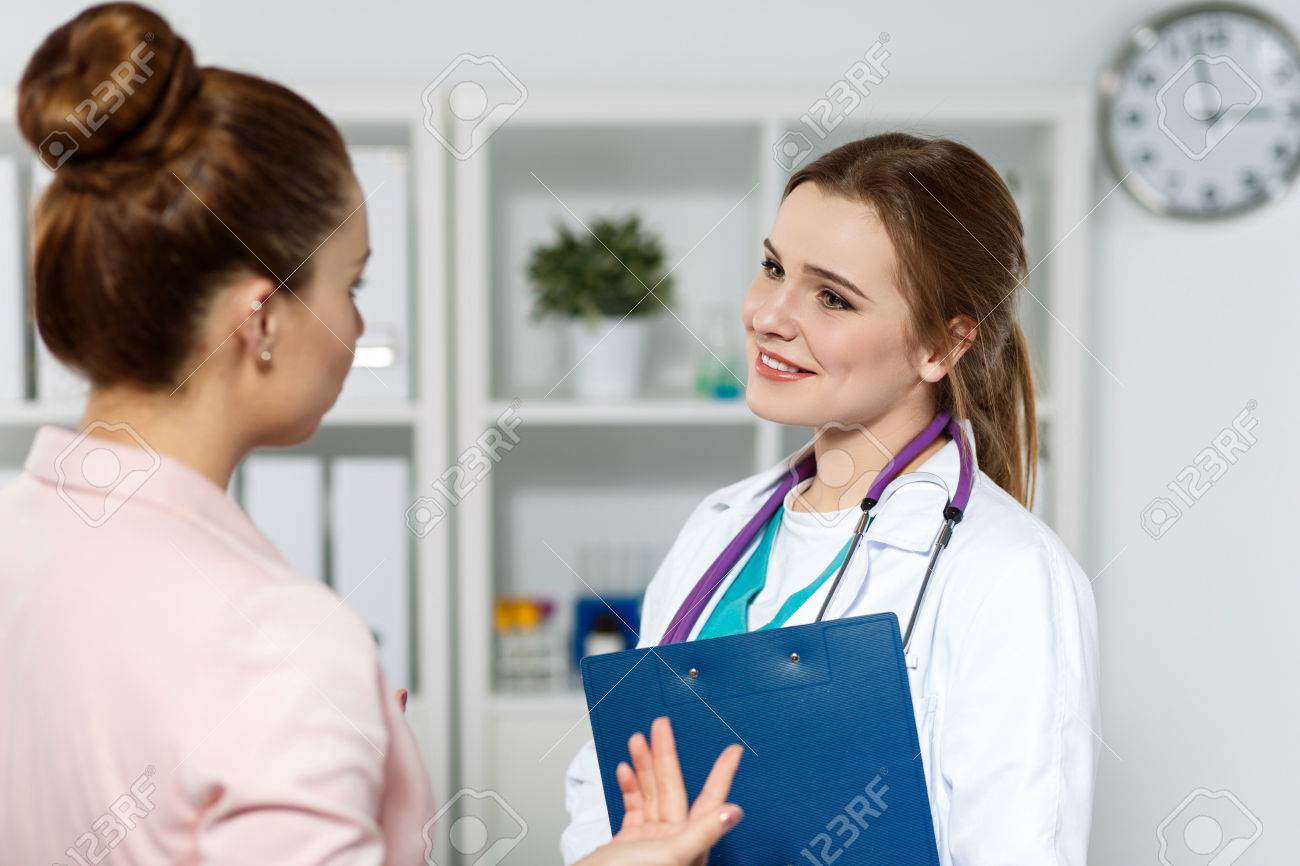 Smiling beautiful female medicine doctor communicating and joking with patient. Medical care or insurance concept. Physician ready to examine patient and help. Partnership trust and ethics concept - 49794205 Smiling beautiful female medicine doctor communicating and joking with patient. Medical care or insurance concept. Physician ready to examine patient and help. Partnership trust and ethics concept - 49794205