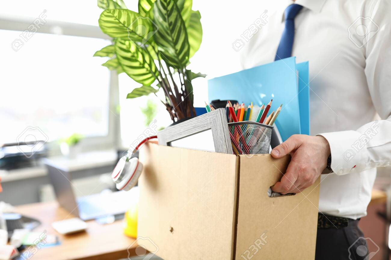 Businessman got fired during covid economy recession and taking his property out from office close-up - 149629493 Businessman got fired during covid economy recession and taking his property out from office close-up - 149629493