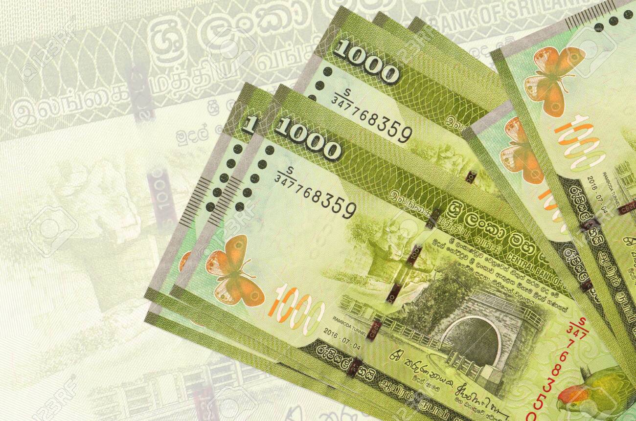 1000 Sri Lankan Rupees Bills Lies In Stack On Background Of Big Semi-transparent Banknote. Abstract Presentation Of National Currency. Business Concept Stock Photo, Picture And Royalty Free Image. Image 157754510.