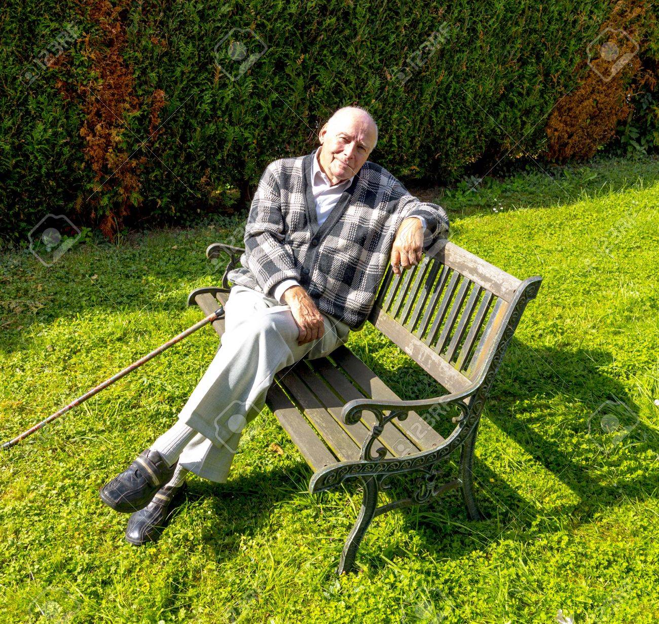 Old Man Enjoys Sitting On A Bench In His Garden Stock Photo, Picture And  Royalty Free Image. Image 15672027.