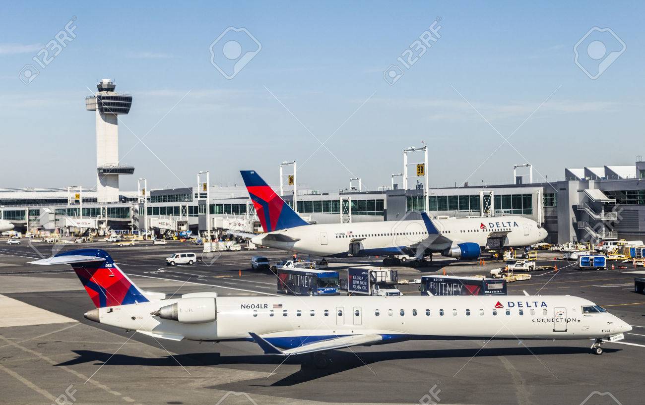 NEW YORK, USA - OCT 20, 2015: Air Traffic Control Tower and Terminal 4 with Delta Air planes at the gates in JFK Airport in NY. 1963 the airport was rededicated John F. Kennedy International Airport. - 47160680 NEW YORK, USA - OCT 20, 2015: Air Traffic Control Tower and Terminal 4 with Delta Air planes at the gates in JFK Airport in NY. 1963 the airport was rededicated John F. Kennedy International Airport. - 47160680