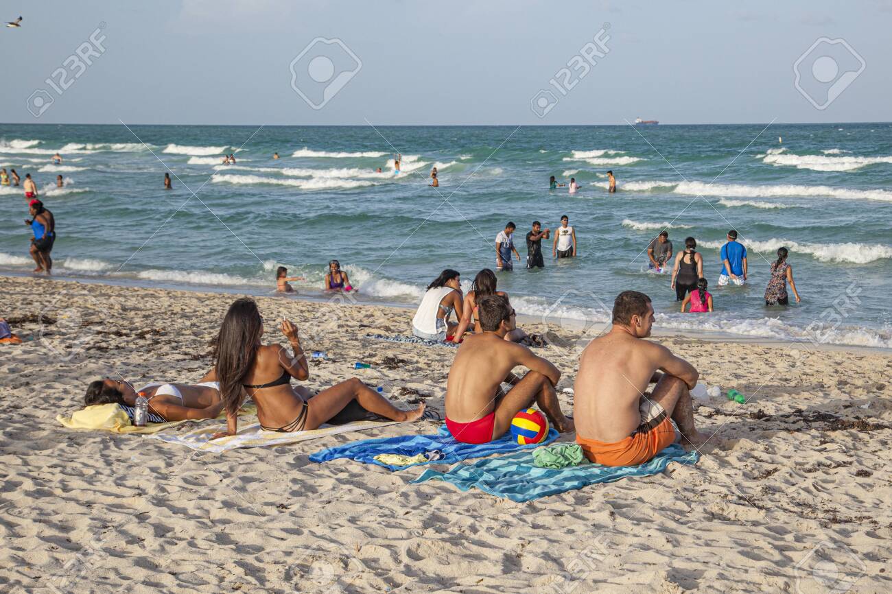 Miami, USA - August 30, 2014: People Enjoy The Famous South Beach In Miami  Beach And Relax In Afternoon Sun. Stock Photo, Picture and Royalty Free  Image. Image 146913360., image size:1300x866