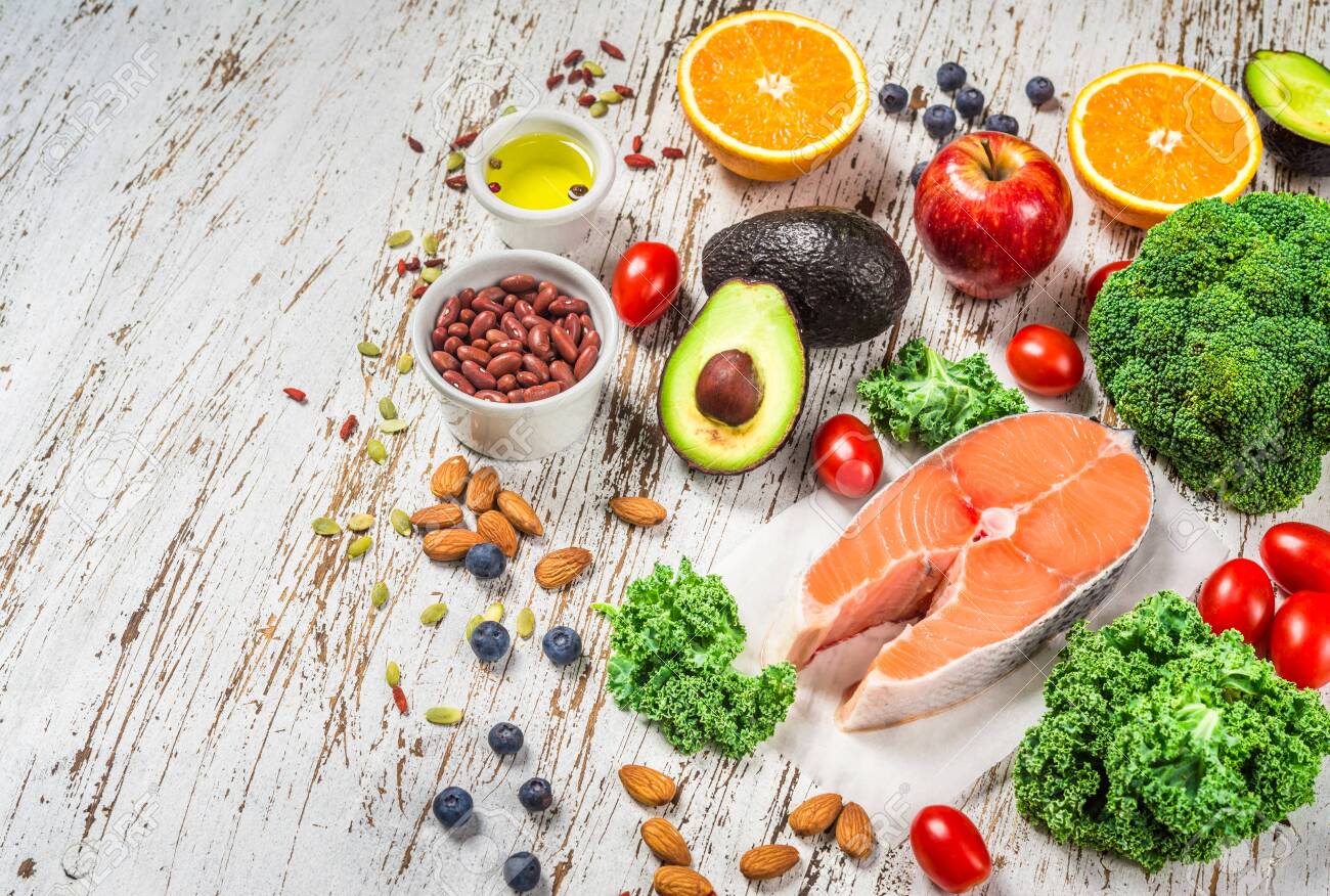 Selection of fresh fruit and vegetables, salmon, beans, and nuts. - 131291477 Selection of fresh fruit and vegetables, salmon, beans, and nuts. - 131291477