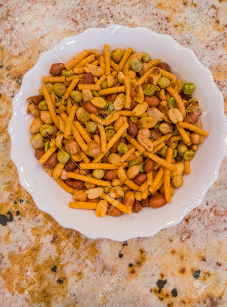assorted snacks and nuts in small bowl on party table stock photo