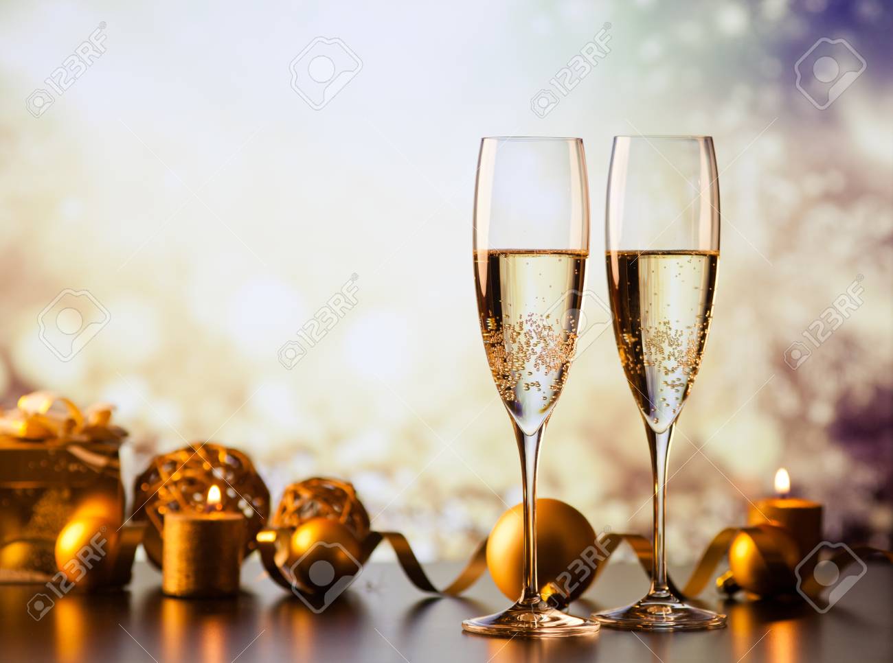 two champagne glasses against holiday lights and fireworks - new year celebration - 89411156 two champagne glasses against holiday lights and fireworks - new year celebration - 89411156