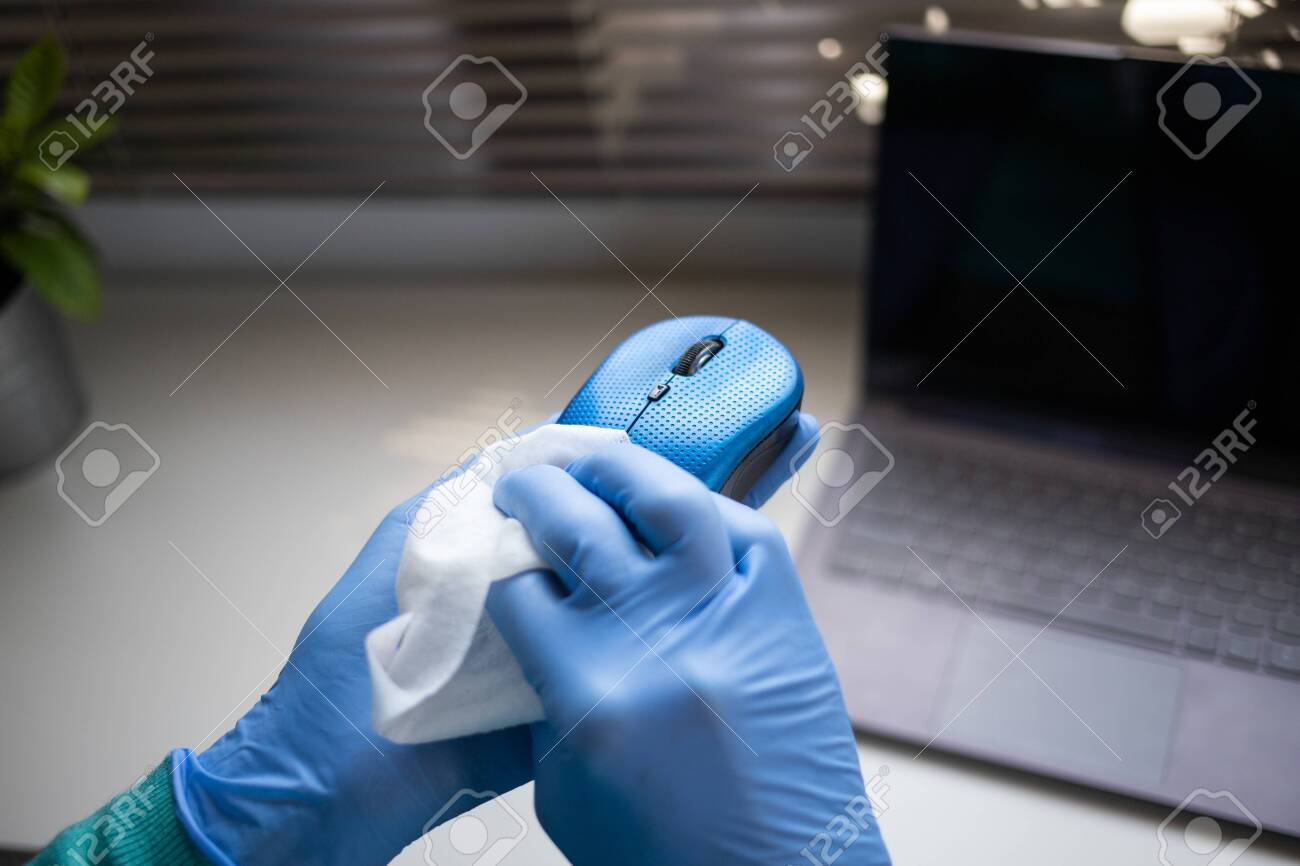 Office sanitizing wipe wiping mouse and mousepad with disinfecting wipes. Coronavirus COVID-19 sanitize cleaning disinfection of work desk. - 144848009 Office sanitizing wipe wiping mouse and mousepad with disinfecting wipes. Coronavirus COVID-19 sanitize cleaning disinfection of work desk. - 144848009