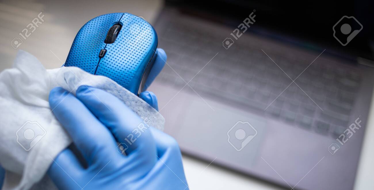 Office sanitizing wipe wiping mouse and mousepad with disinfecting wipes. Coronavirus COVID-19 sanitize cleaning disinfection of work desk. - 144848372 Office sanitizing wipe wiping mouse and mousepad with disinfecting wipes. Coronavirus COVID-19 sanitize cleaning disinfection of work desk. - 144848372