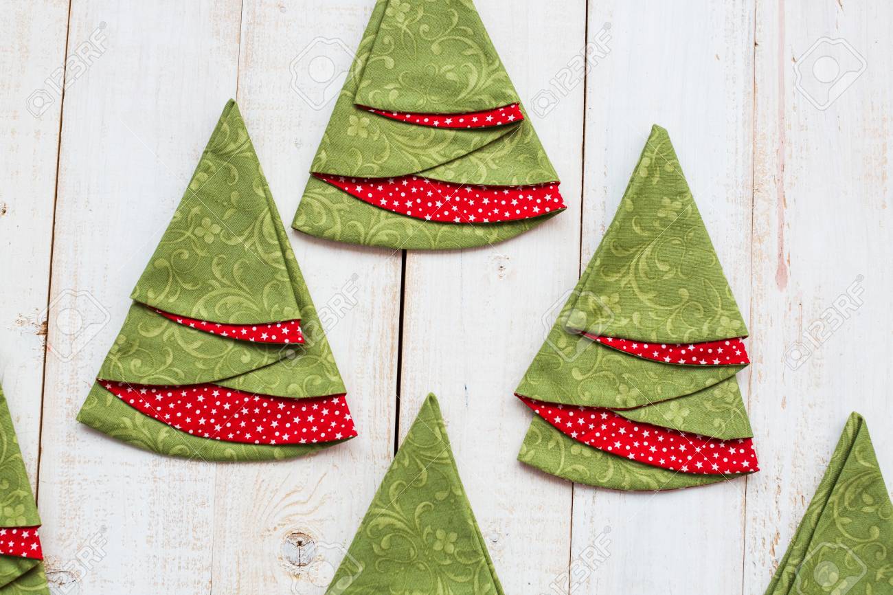 パッチワークとキルト コンセプト 白塗り木製の床 クリスマス ツリー 刺繍製品 トップ ビューの形でお祝いタオルにカラフルな装飾的な赤緑のナプキンのマクロ フラットを置く の写真素材 画像素材 Image