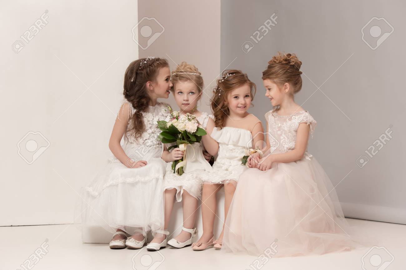 Little pretty girls with flowers dressed in wedding dresses - 97812378 Little pretty girls with flowers dressed in wedding dresses - 97812378