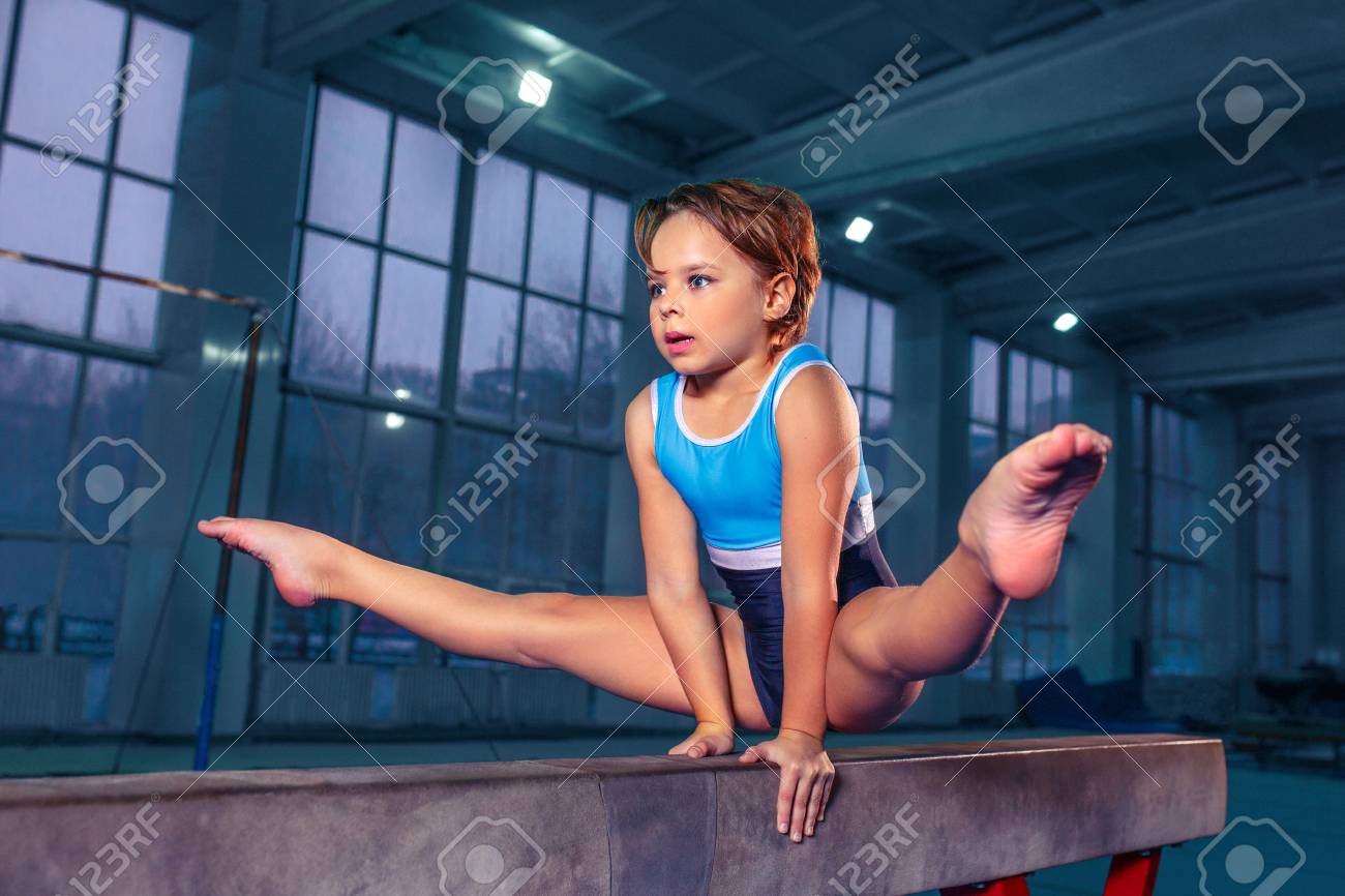 Young little girls gymnastics The Beautiful Little Girl Is Engaged In Sports Gymnastics On A Log At Gym.  Stock Photo, Picture and Royalty Free Image. Image 113874467.