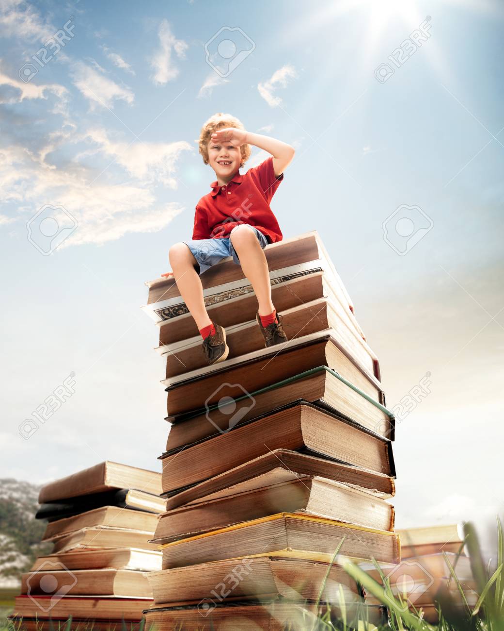 Little boy sitting on the tower made of big books. Childhood dreams, reading and education concept. Wondering world. abstract collage - 117841119 Little boy sitting on the tower made of big books. Childhood dreams, reading and education concept. Wondering world. abstract collage - 117841119