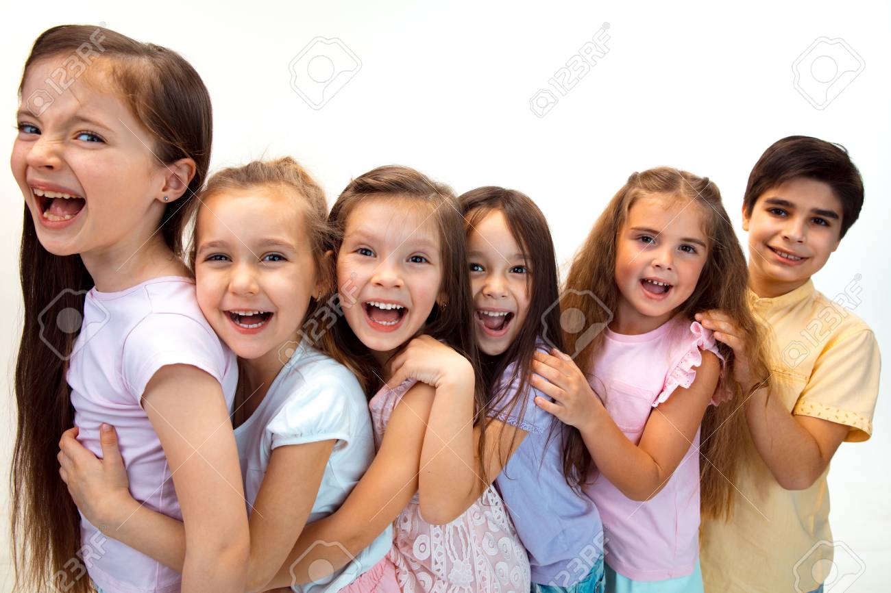 The portrait of happy cute little kids boy and girls in stylish casual clothes looking at camera against white studio wall. Kids fashion and human emotions concept - 120051052 The portrait of happy cute little kids boy and girls in stylish casual clothes looking at camera against white studio wall. Kids fashion and human emotions concept - 120051052