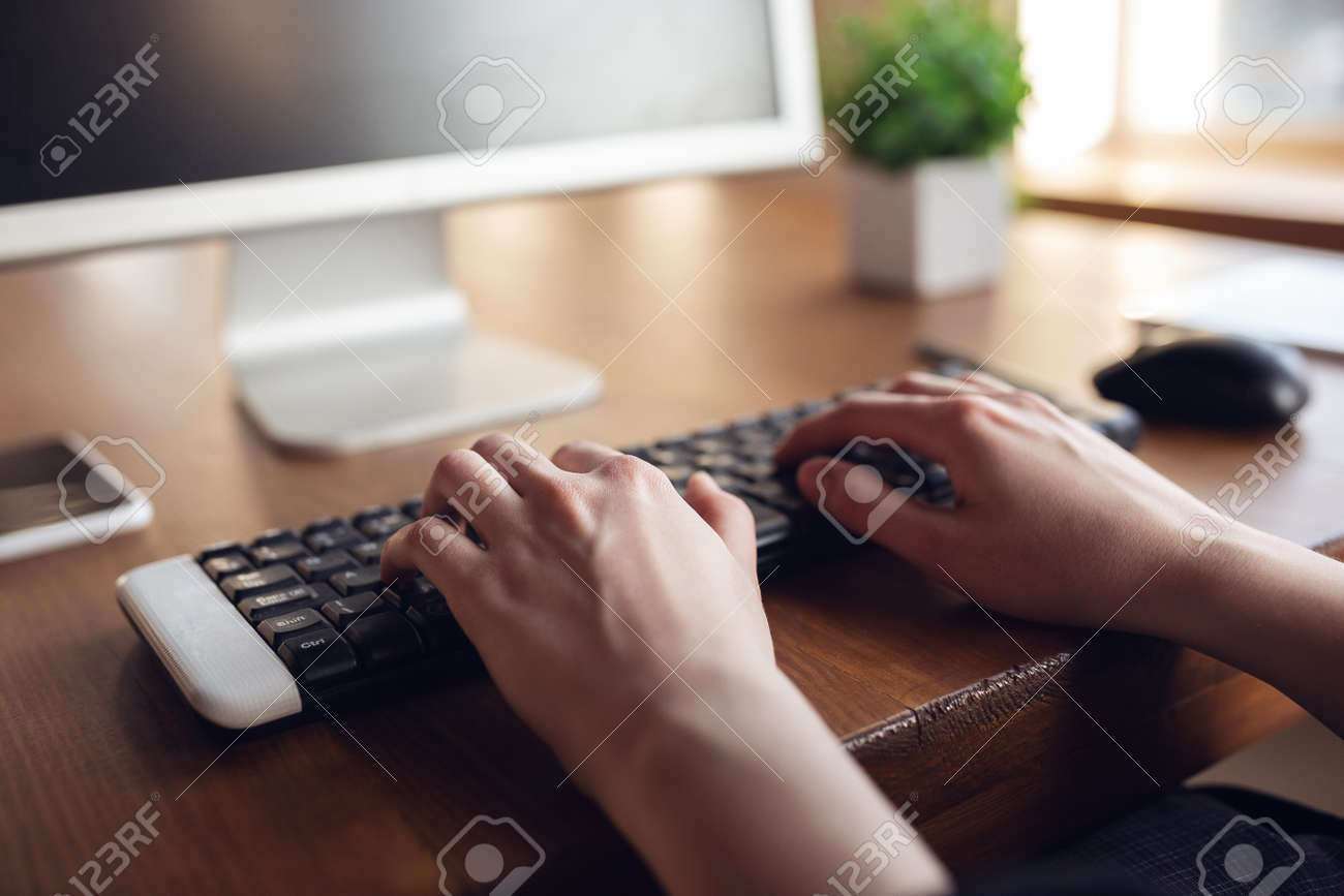 Typing text, close up. Caucasian young woman in business attire working in office. Young businesswoman, manager doing tasks with smartphone, laptop, tablet has online conference. Finance, job. - 144567035 Typing text, close up. Caucasian young woman in business attire working in office. Young businesswoman, manager doing tasks with smartphone, laptop, tablet has online conference. Finance, job. - 144567035