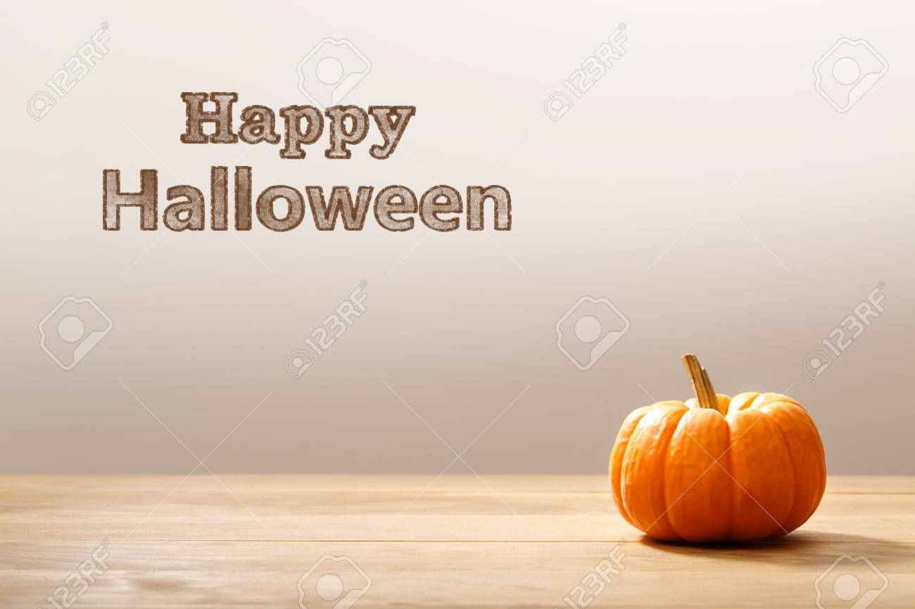 happy halloween message with a orange small pumpkin stock photo