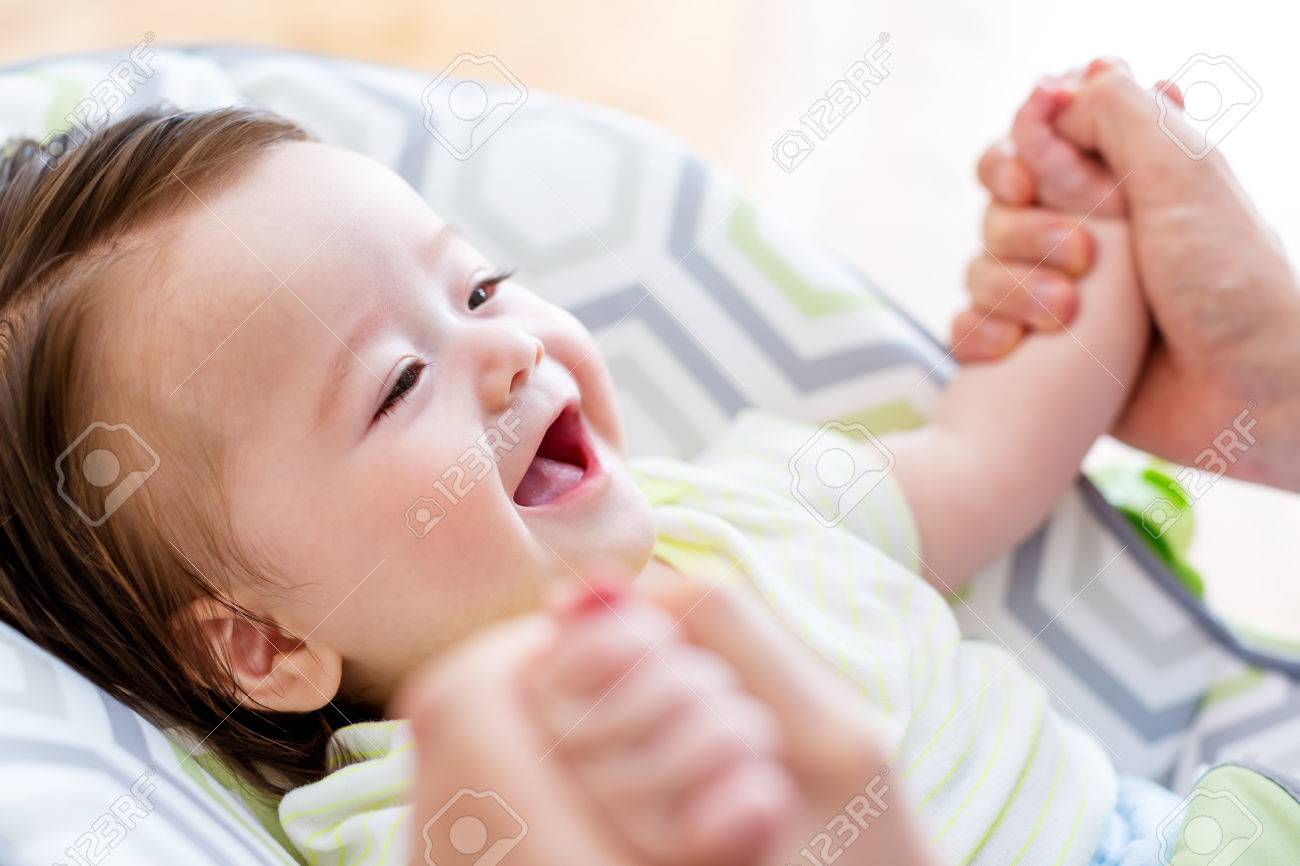 Happy baby boy playing with his parent in his house - 81367501 Happy baby boy playing with his parent in his house - 81367501