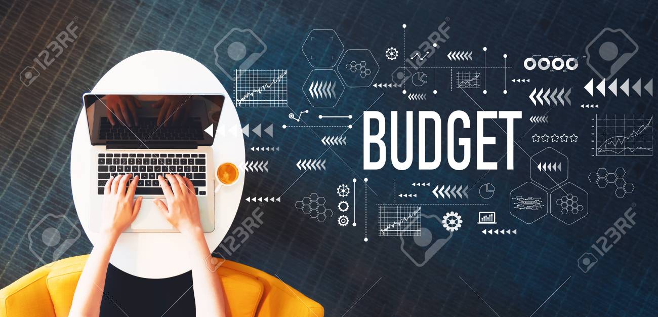 Budget with person using a laptop on a white table - 110708011 Budget with person using a laptop on a white table - 110708011
