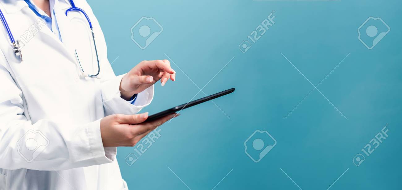 Medical doctor with digital tablet on a blue background - 111662334 Medical doctor with digital tablet on a blue background - 111662334