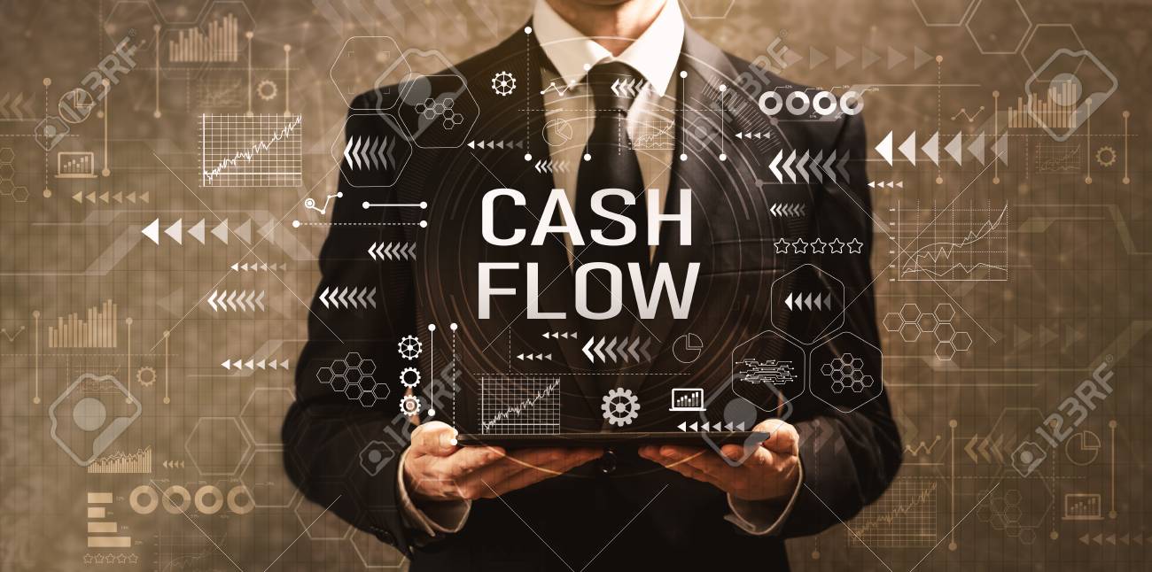 Cash flow with businessman holding a tablet computer on a dark vintage background - 111744685 Cash flow with businessman holding a tablet computer on a dark vintage background - 111744685