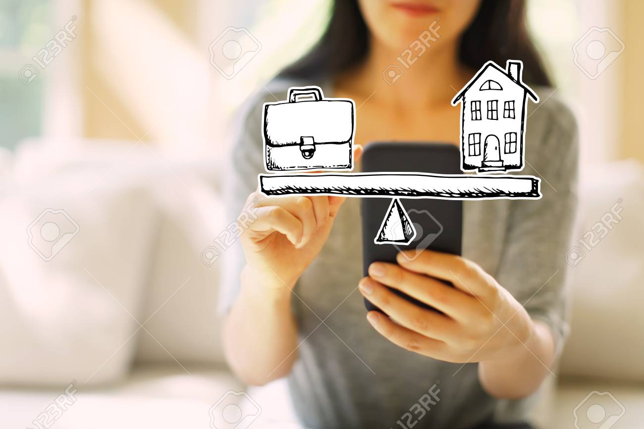 Work and life balance with woman using her smartphone in a living room - 116956621 Work and life balance with woman using her smartphone in a living room - 116956621